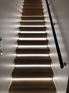 Staircase with handrail and lights recessed into stair risers